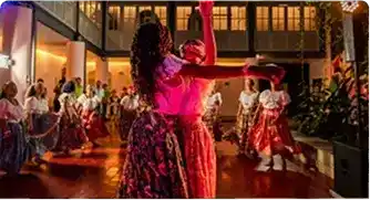 Group of young dancers in colorful full skirts performing a large Brazilian folk dance show