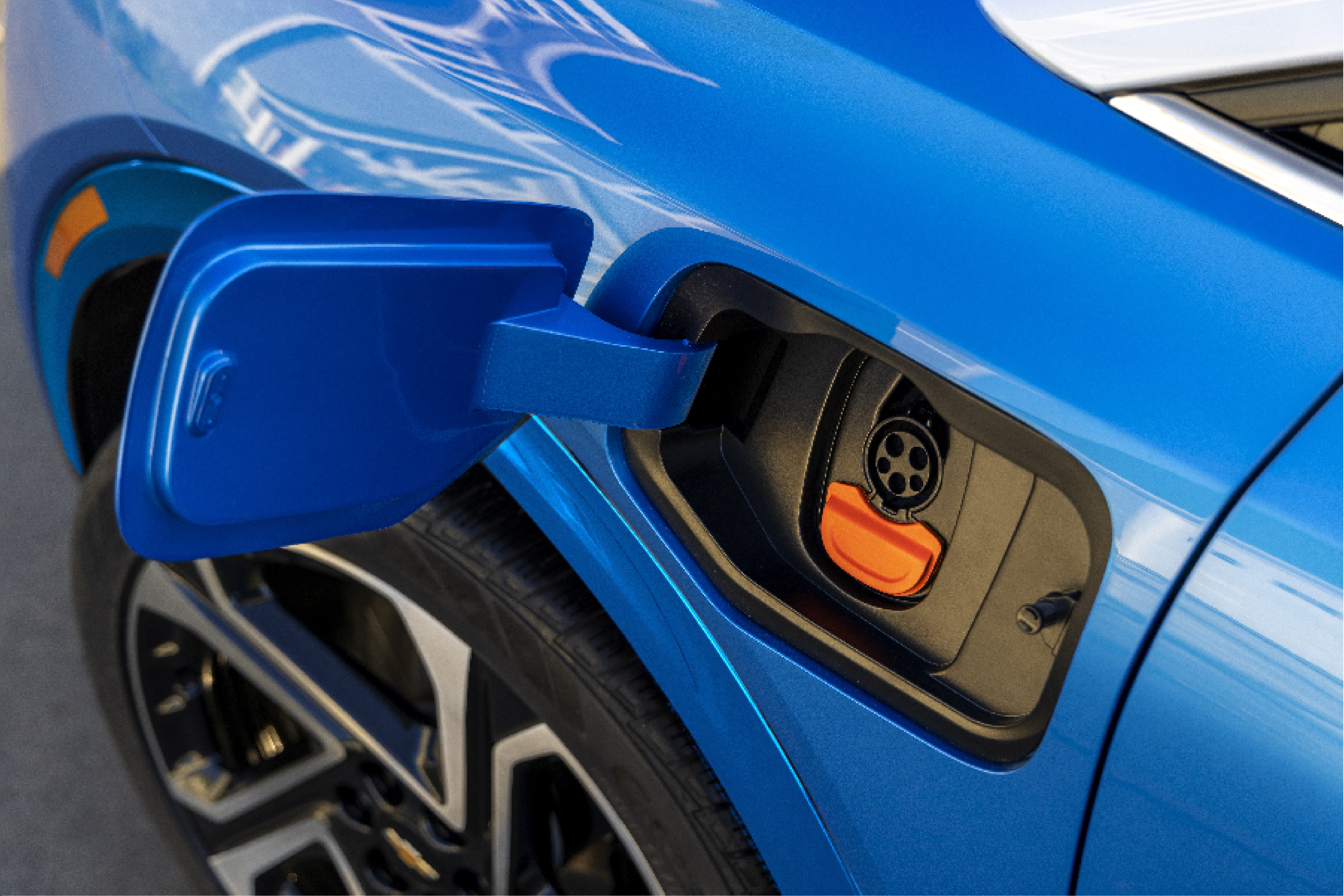 Photo of the part of a blue car where you put fuel.