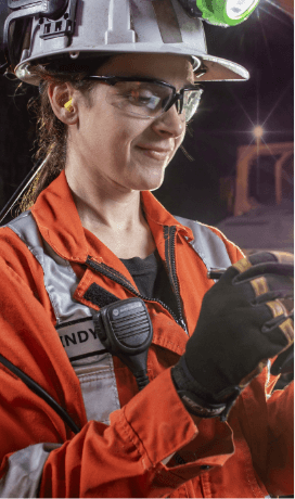 A Vale employee wearing protective glasses, helmet and gloves