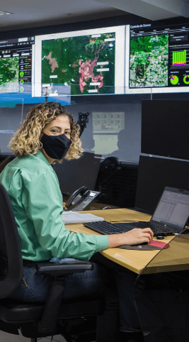 A woman with short, curly blonde hair monitoring Vale's dams using computers