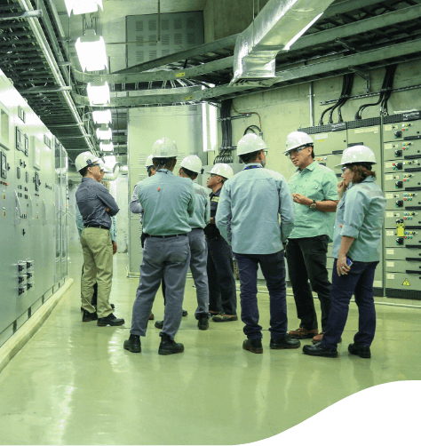 Group of uniformed employees chat inside the work sites.