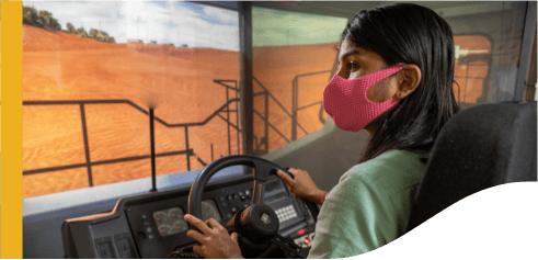 Vale's employee is driving a truck. She is wearing protective mask